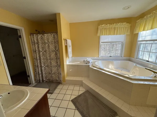 a bathroom with a bathtub and shower