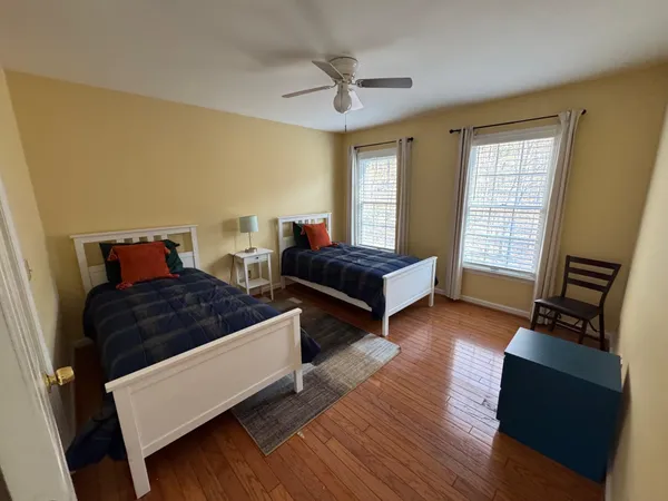a bedroom with two beds and a window