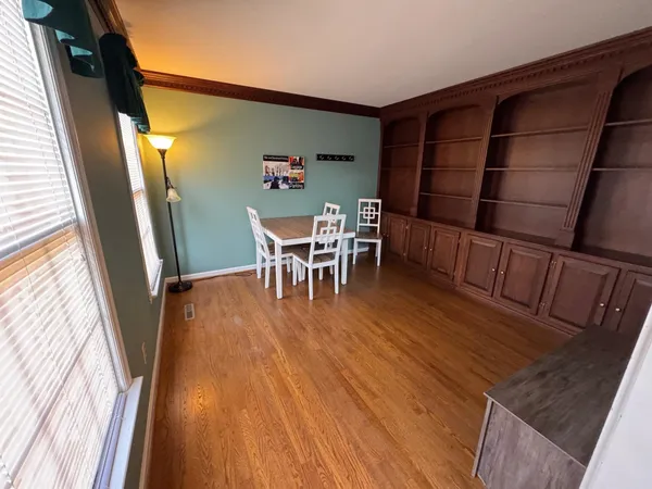 a view of a dining room with furniture window and wooden floor
