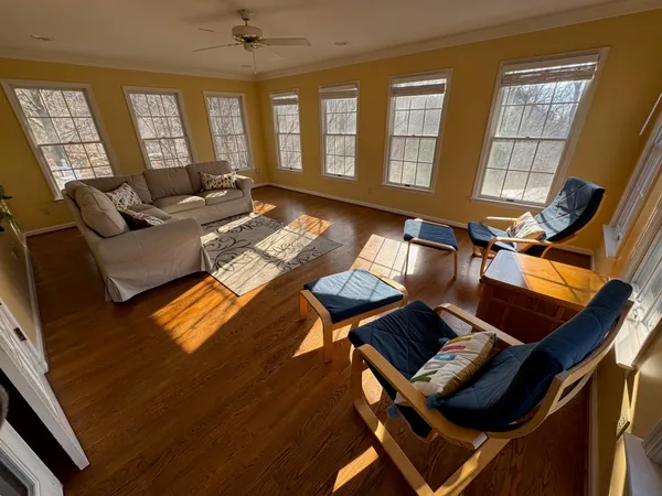 a living room with furniture and wooden floor