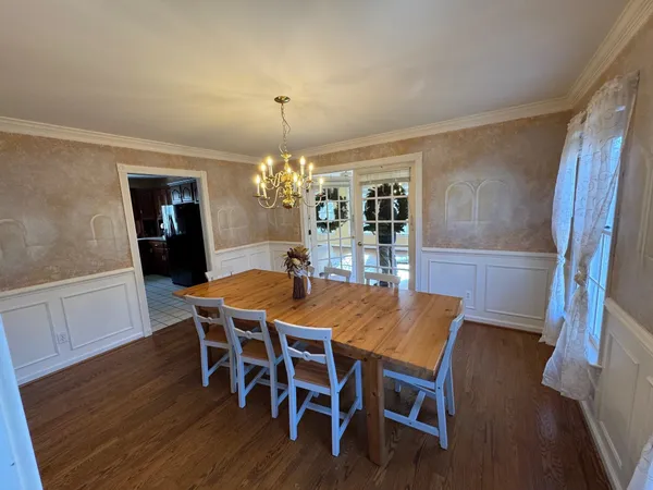 a view of a dining room with furniture and wooden floor