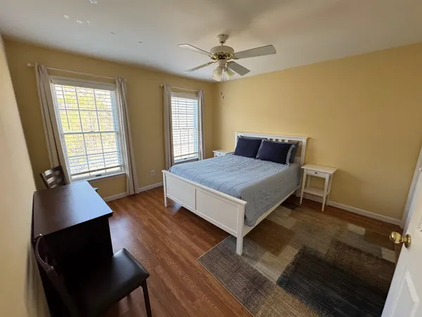 a bedroom with a bed and a window