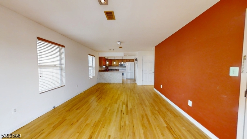534 Maple Avenue Elizabeth, NJ 07202 - Photo 12 of 48 a view of a bedroom with wooden floor and a window