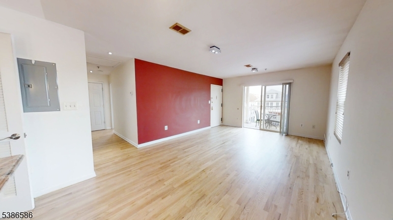 534 Maple Avenue Elizabeth, NJ 07202 - Photo 13 of 48 a view of an empty room with wooden floor and a window
