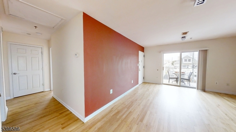 534 Maple Avenue Elizabeth, NJ 07202 - Photo 15 of 48 a view of an empty room with wooden floor and a window