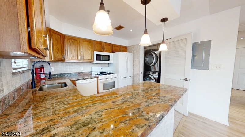 534 Maple Avenue Elizabeth, NJ 07202 - Photo 17 of 48 a kitchen with stainless steel appliances granite countertop a sink refrigerator and cabinets