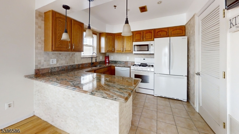 534 Maple Avenue Elizabeth, NJ 07202 - Photo 18 of 48 a kitchen with stainless steel appliances granite countertop a sink stove and refrigerator