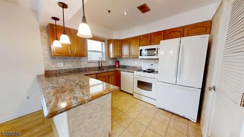534 Maple Avenue Elizabeth, NJ 07202 - Photo 19 of 48 a kitchen with stainless steel appliances granite countertop a refrigerator a stove a sink and a refrigerator