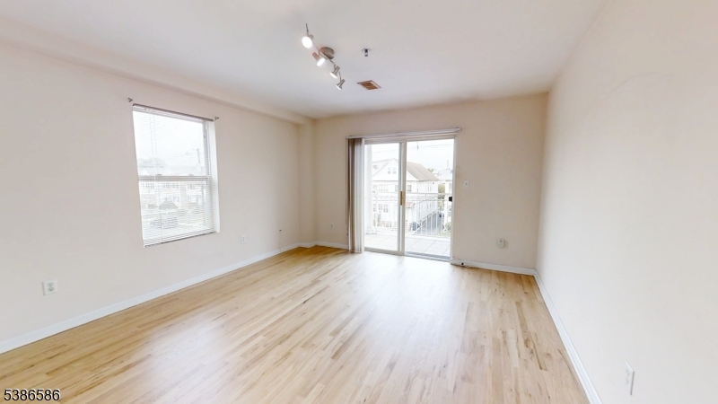 534 Maple Avenue Elizabeth, NJ 07202 - Photo 25 of 48 an empty room with wooden floor and windows