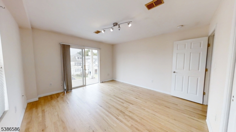534 Maple Avenue Elizabeth, NJ 07202 - Photo 30 of 48 an empty room with wooden floor and windows