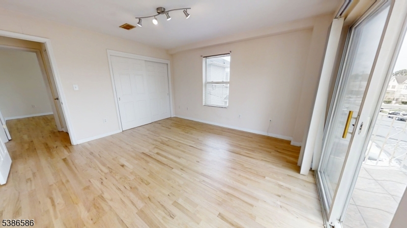 534 Maple Avenue Elizabeth, NJ 07202 - Photo 33 of 48 a view of empty room with wooden floor and fan