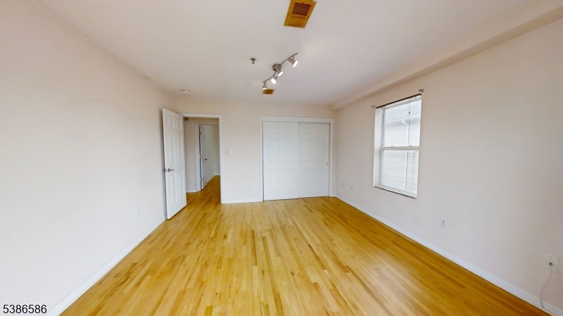 534 Maple Avenue Elizabeth, NJ 07202 - Photo 34 of 48 a view of a bedroom with wooden floor and windows