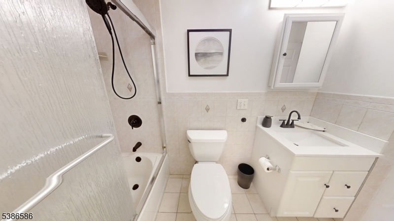 534 Maple Avenue Elizabeth, NJ 07202 - Photo 37 of 48 a bathroom with a sink and mirror with bathtub