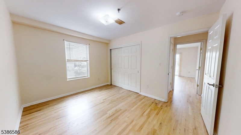 534 Maple Avenue Elizabeth, NJ 07202 - Photo 40 of 48 an empty room with wooden floor and a window