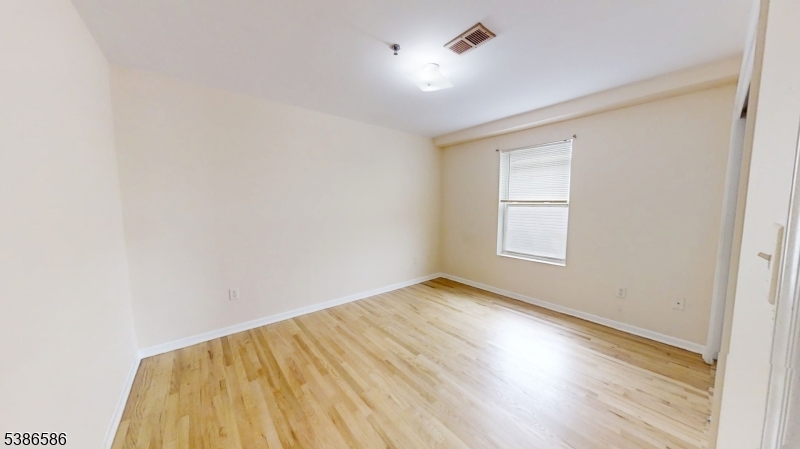 534 Maple Avenue Elizabeth, NJ 07202 - Photo 41 of 48 an empty room with wooden floor and windows