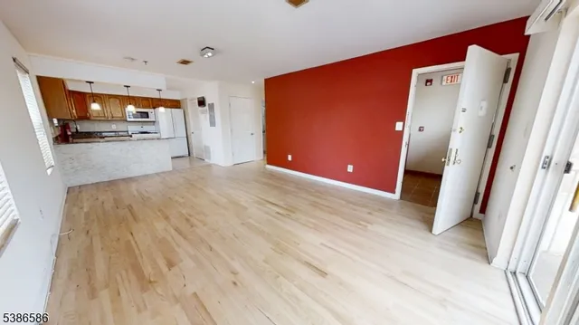 a view of a bedroom with wooden floor