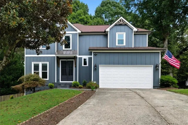 a front view of a house with a garden and plants