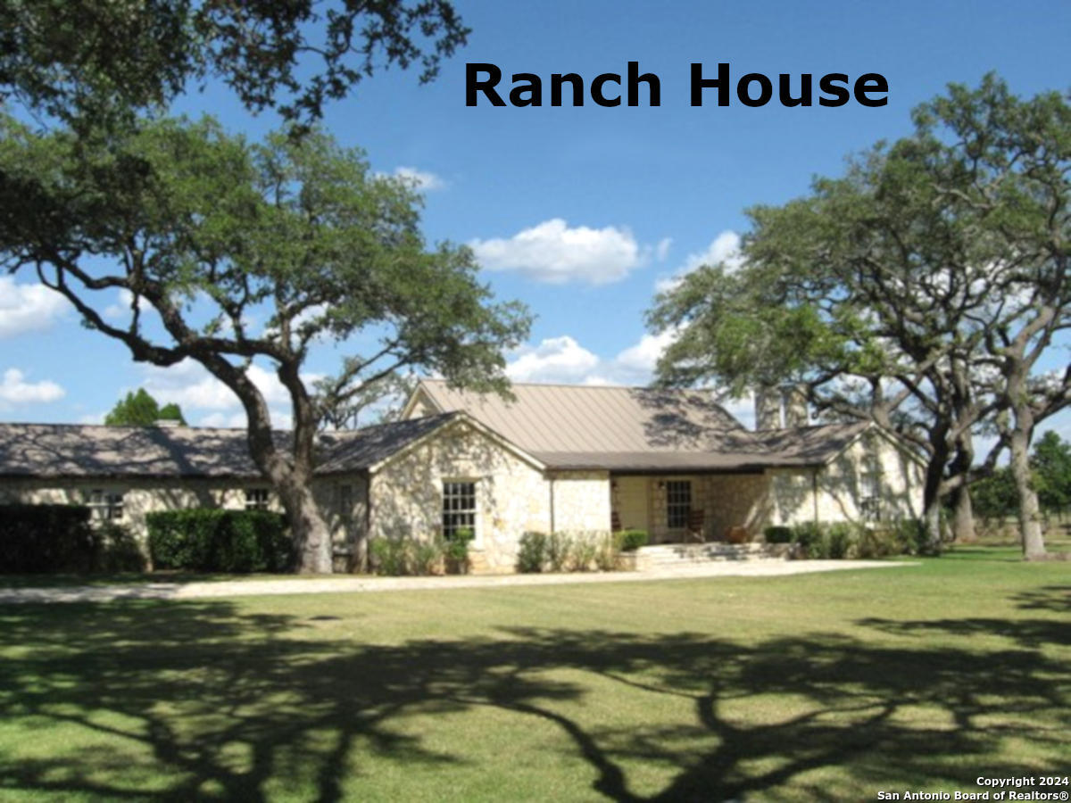 Lot 767 Hager Ridge Bandera, TX 78003 - Photo 19 of 32 a front view of a house with a garden
