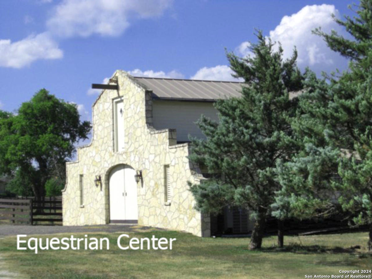 Lot 767 Hager Ridge Bandera, TX 78003 - Photo 22 of 32 a front view of a house with garden