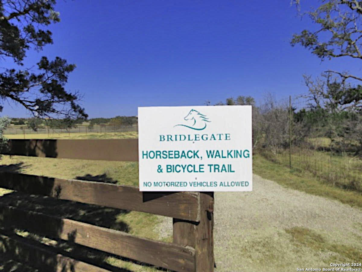 Lot 767 Hager Ridge Bandera, TX 78003 - Photo 25 of 32 a sign on the side of a lake