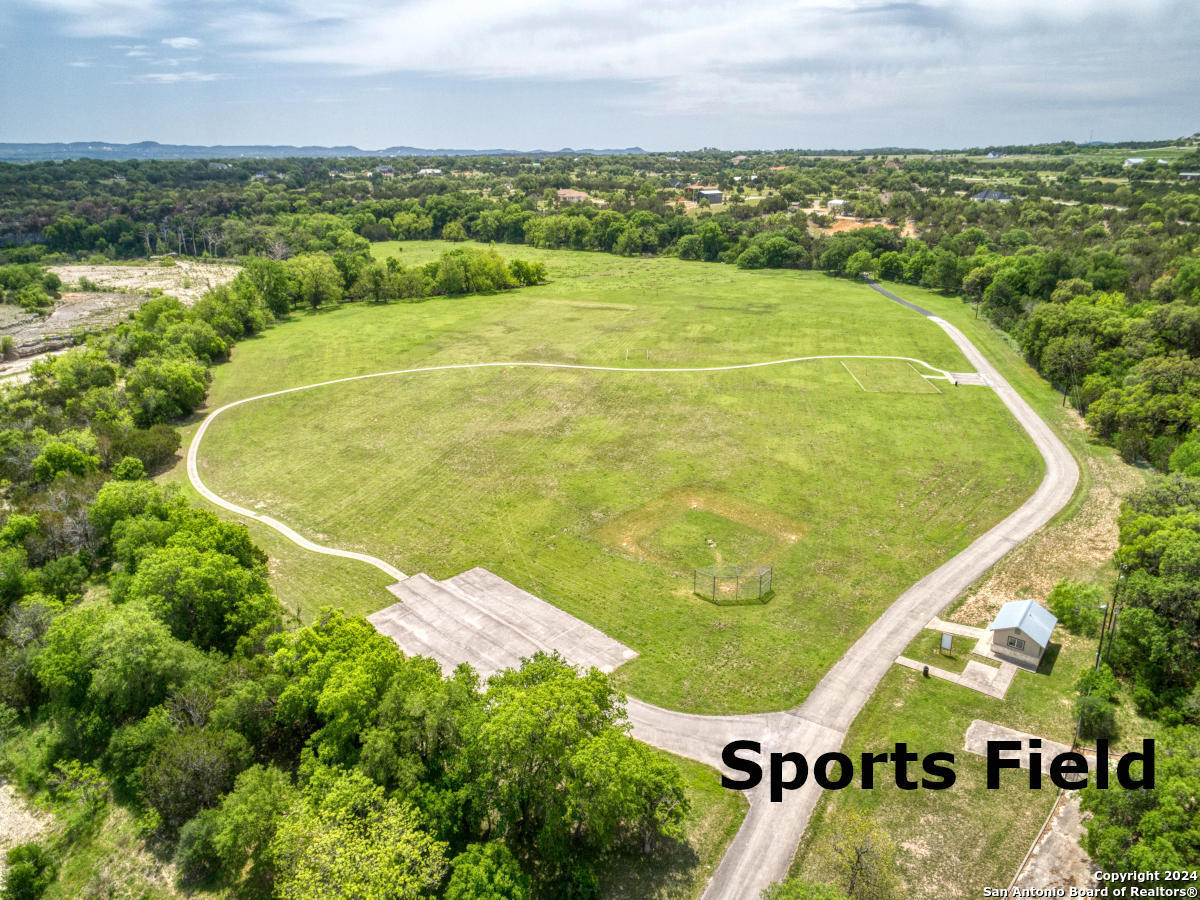 Lot 767 Hager Ridge Bandera, TX 78003 - Photo 27 of 32 an aerial view of residential houses with outdoor space and swimming pool