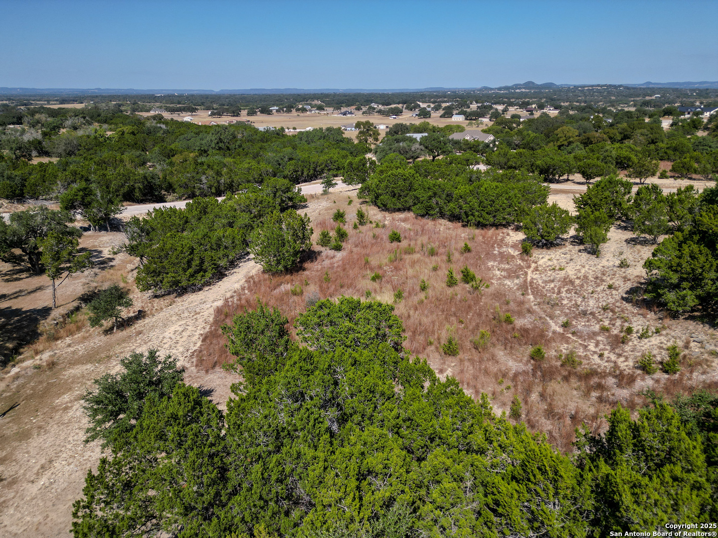 Lot 767 Hager Ridge Bandera, TX 78003 - Photo 4 of 32 an aerial view of a houses with a yard