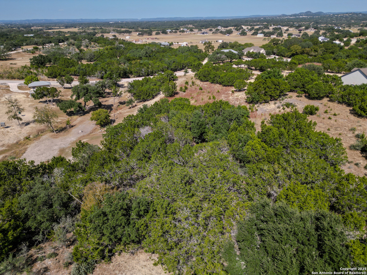Lot 767 Hager Ridge Bandera, TX 78003 - Photo 5 of 32 an aerial view of residential houses with outdoor space and trees