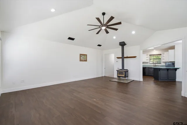 a view of empty room with wooden floor and windows