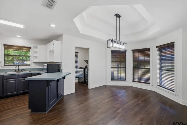 a kitchen with stainless steel appliances granite countertop a stove cabinets and wooden floor