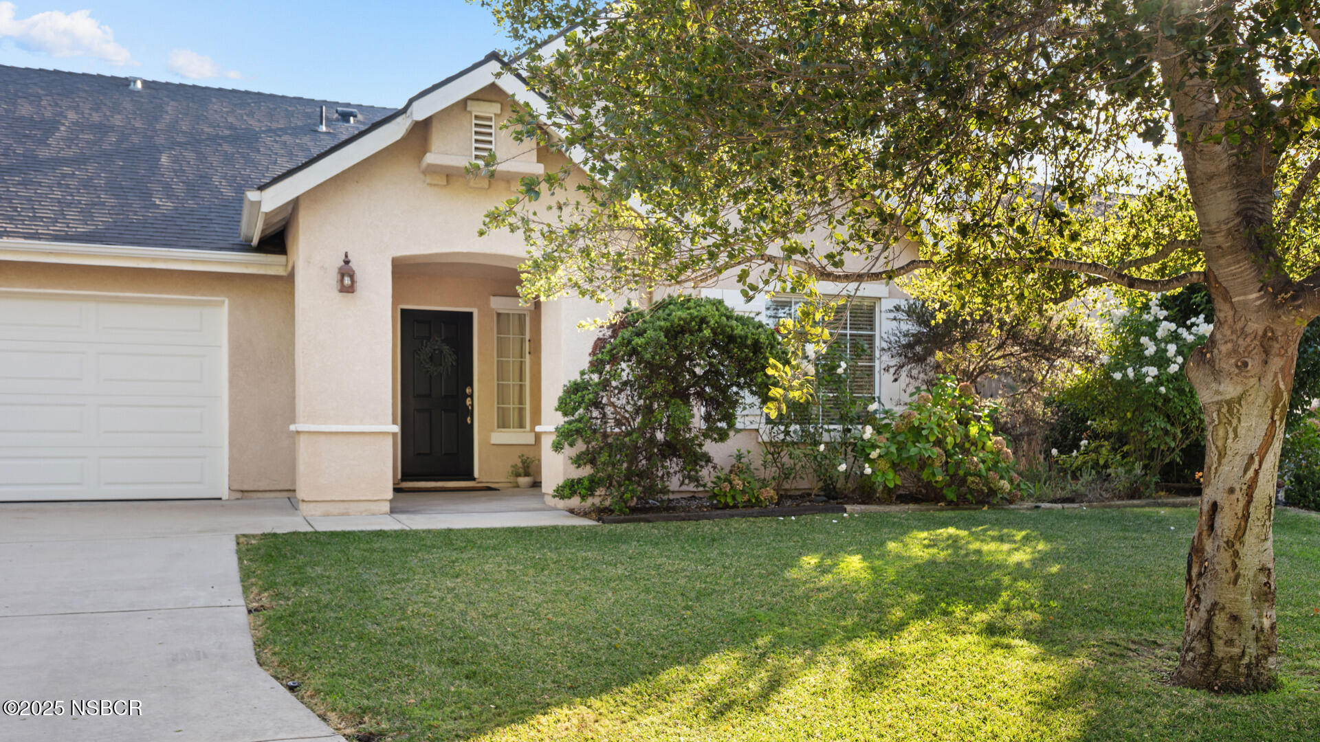 738 Hill Street Los Alamos, CA 93440 - Photo 1 of 27 a view of a white house next to a yard with big trees