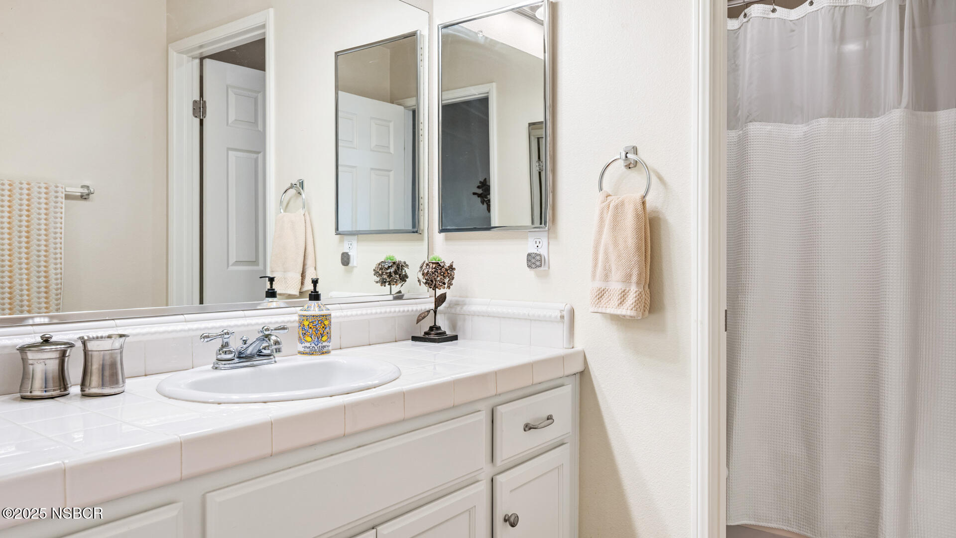 738 Hill Street Los Alamos, CA 93440 - Photo 15 of 27 a bathroom with a sink and a mirror