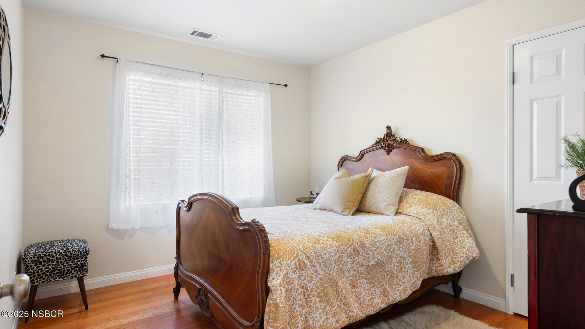 738 Hill Street Los Alamos, CA 93440 - Photo 16 of 27 a bedroom with a bed and a chair