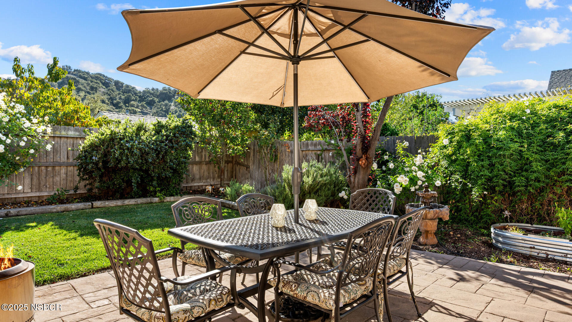 738 Hill Street Los Alamos, CA 93440 - Photo 18 of 27 a patio with a table and chairs under an umbrella