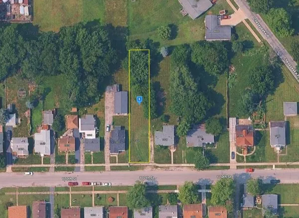 an aerial view of residential houses with outdoor space and street view