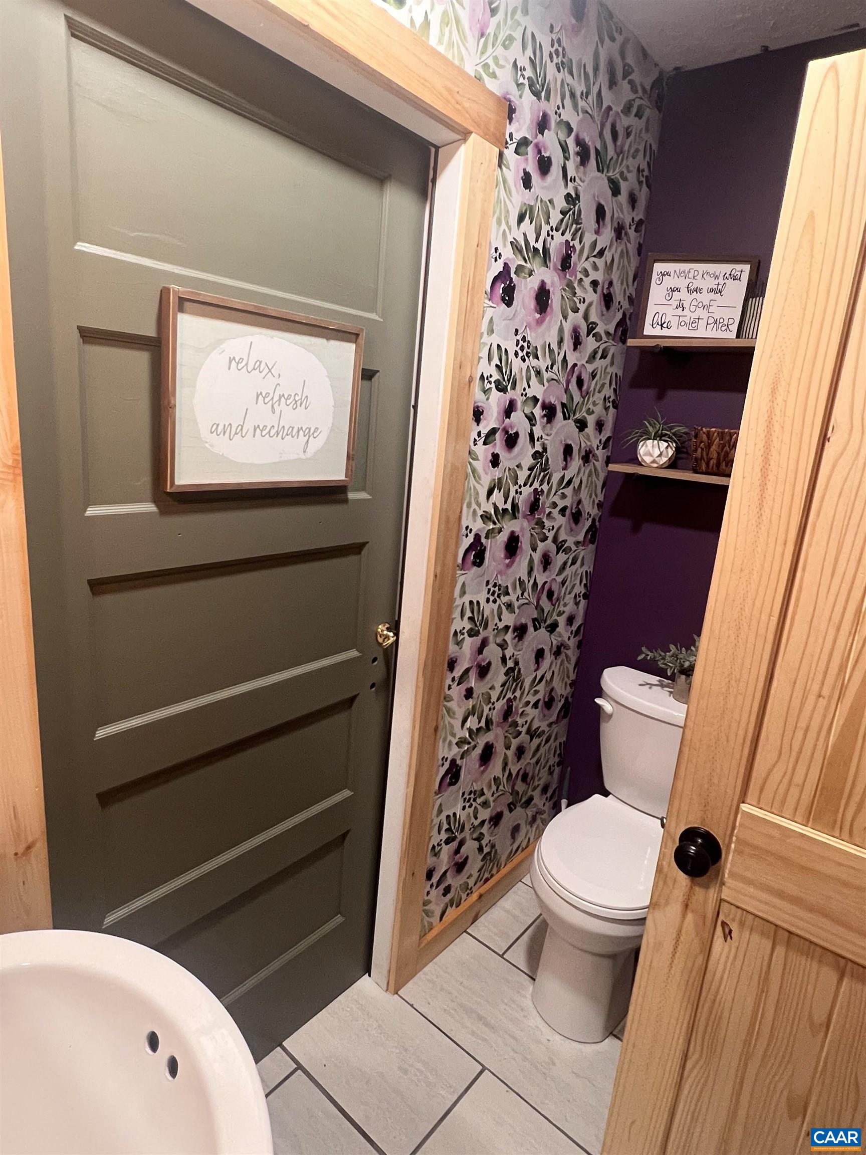 8876 East Timber Ridge Road Mount Crawford, VA 22841 - Photo 31 of 75 a bathroom with a toilet and a shower curtain