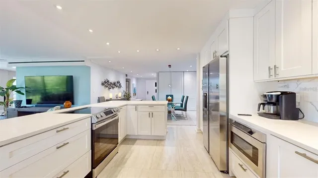 a kitchen with white cabinets and white appliances