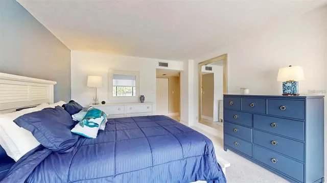 a bedroom with a bed and a dresser