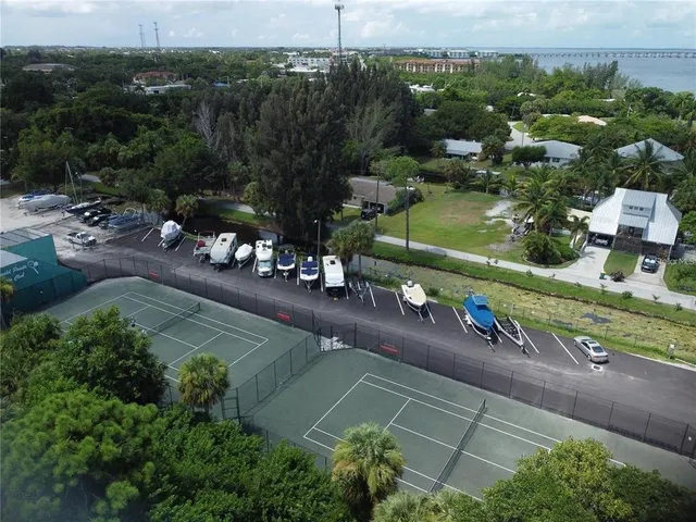 an aerial view of a house with a yard basket ball court and outdoor seating