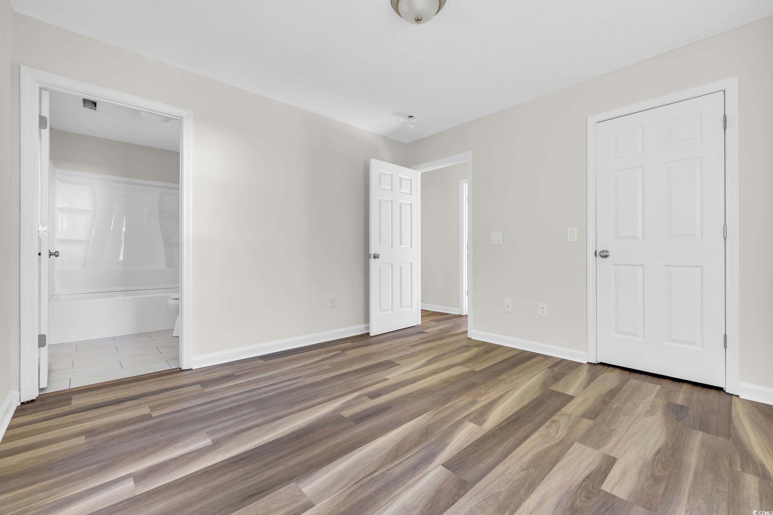 1960 Hampton Street Georgetown, SC 29440 - Photo 17 of 22 Unfurnished bedroom with ensuite bath and dark har