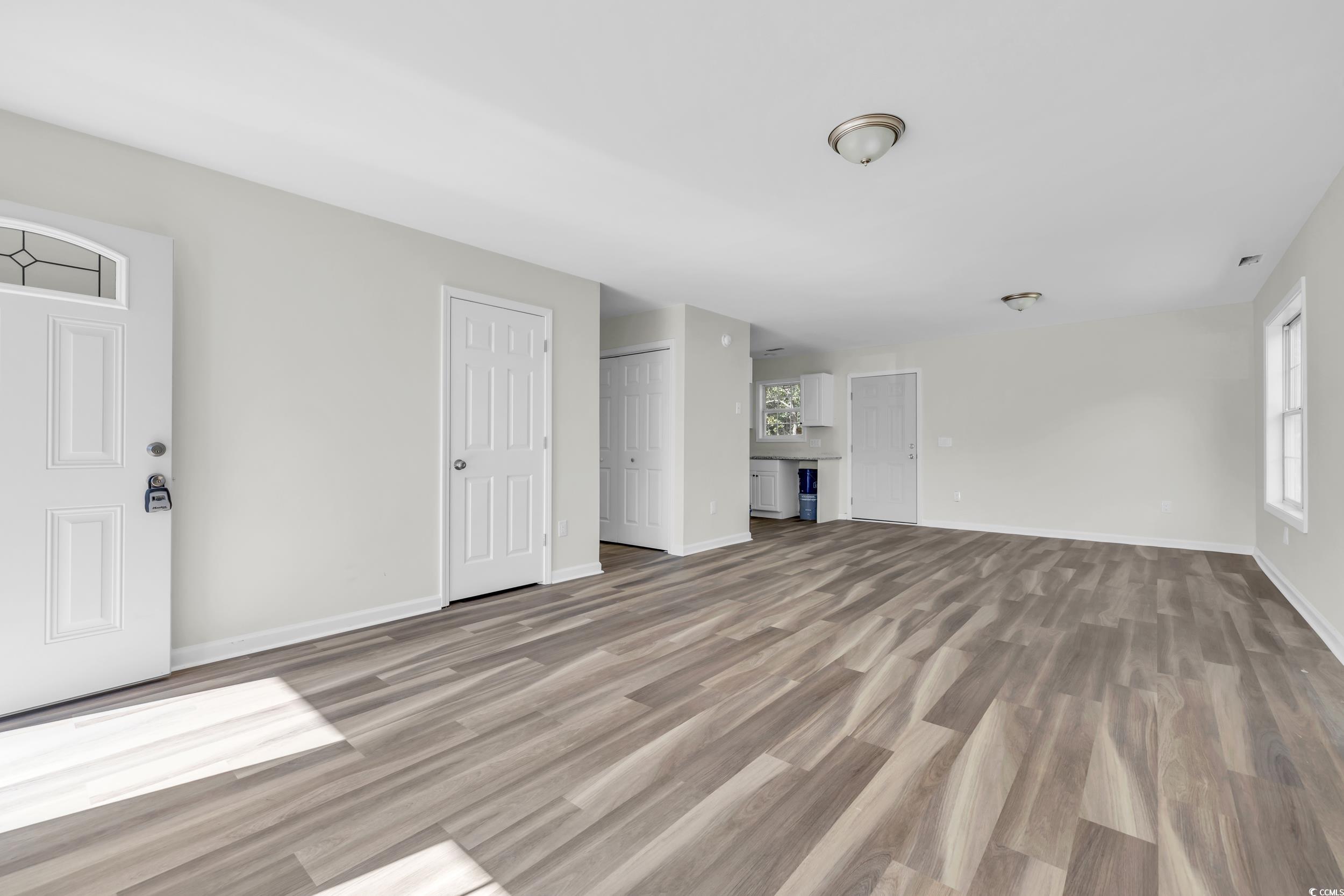 1960 Hampton Street Georgetown, SC 29440 - Photo 3 of 22 Unfurnished living room featuring light hardwood /