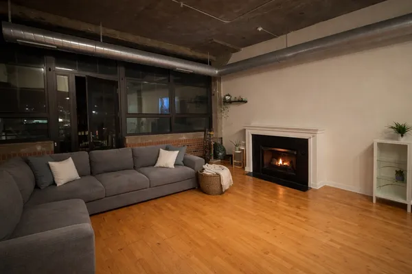 a living room with furniture and a fireplace