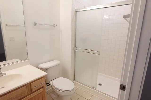 a white toilet sitting next to a bathroom sink