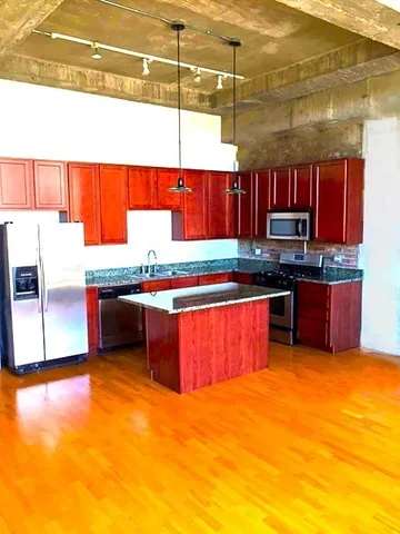 a kitchen with stainless steel appliances granite countertop a stove and a sink