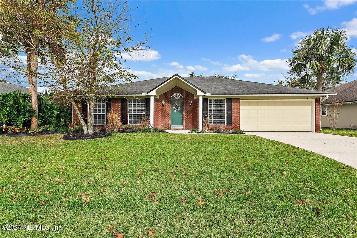 12417 Nesting Eagles Way Jacksonville, FL 32225 - Photo 1 of 23 a front view of a house with garden