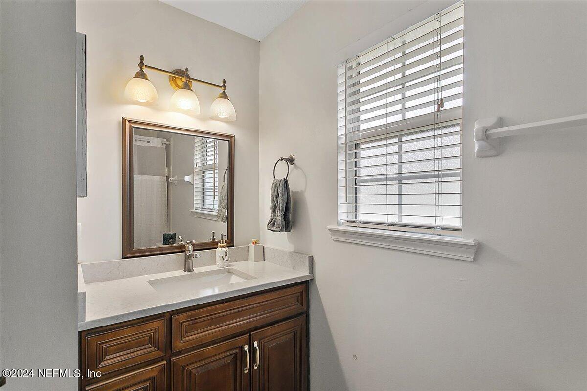 12417 Nesting Eagles Way Jacksonville, FL 32225 - Photo 14 of 23 a bathroom with a sink a vanity and a mirror