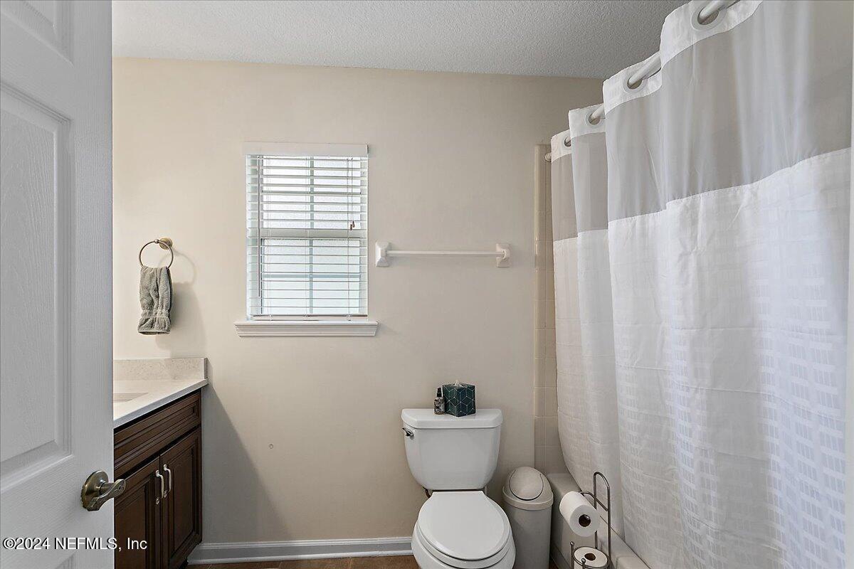 12417 Nesting Eagles Way Jacksonville, FL 32225 - Photo 15 of 23 a bathroom with a toilet a sink and a window