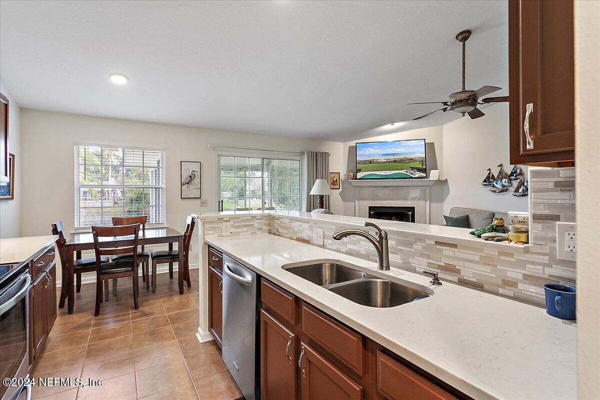 12417 Nesting Eagles Way Jacksonville, FL 32225 - Photo 8 of 23 a kitchen with a sink a counter top space and stainless steel appliances