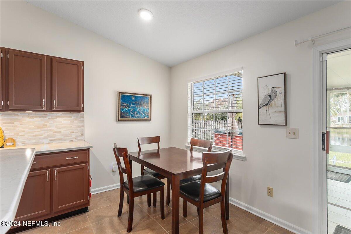 12417 Nesting Eagles Way Jacksonville, FL 32225 - Photo 10 of 23 a view of a dining room with furniture and window