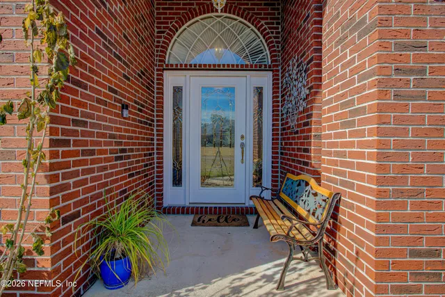 a view of a dining room with furniture and a chandelier