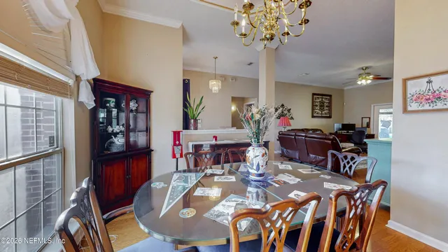 a bedroom with bed and a chandelier
